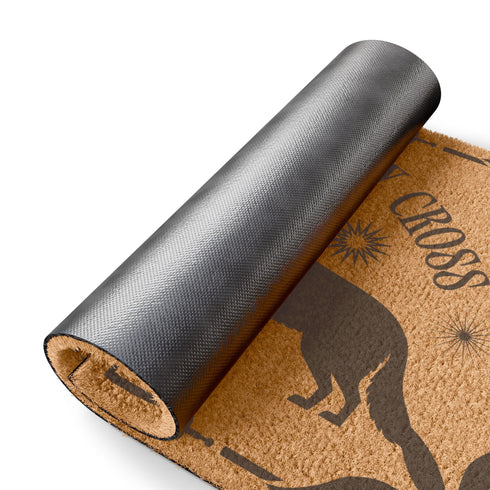 Natural coir doormat featuring black silhouettes of two howling wolves in symmetrical formation, surrounded by celestial and botanical details. The phrase No Shadows May Cross is hand-stenciled above, with a non-slip vinyl backing for outdoor use.